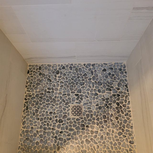 Finished shower interior from ceiling to pebble mosaic floor